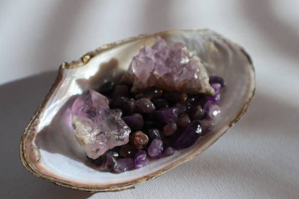 istock Amethyst druse and amethyst kiesel in shell on the table. 2135130476