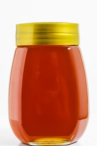 One Full Honey Jar on a White Background