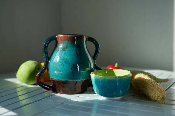 Still life with corn, pear, pepper and an old ceramic jug. Healthy eating concept. High quality photo