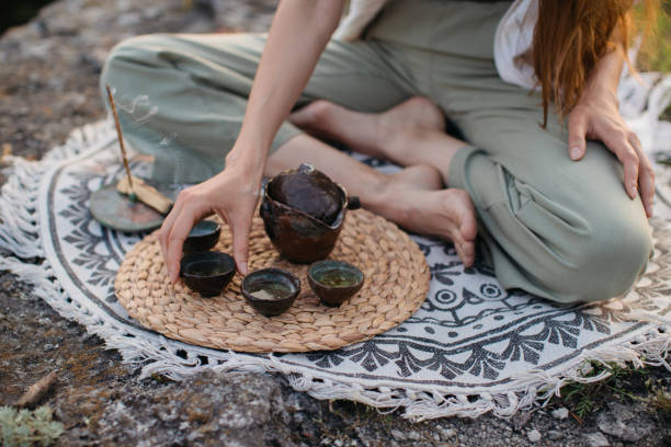 istock A young beautiful woman performs a Chinese tea ceremony in the mountains at sunset. 2135151004