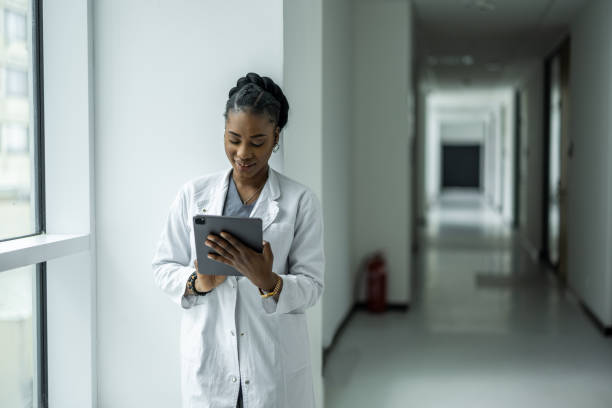 istock Female doctor using digital tablet in clinic hallway 2135175177