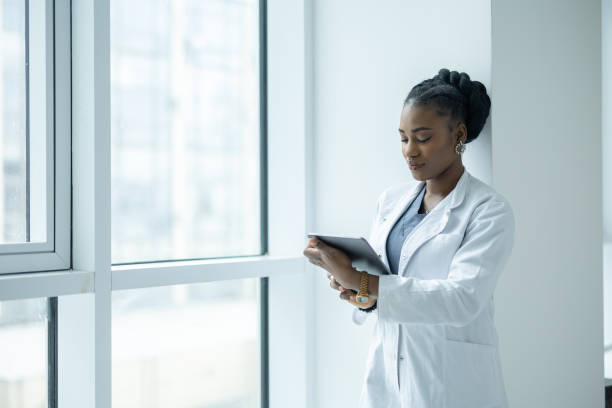 istock Female doctor using digital tablet in clinic hallway 2135176247