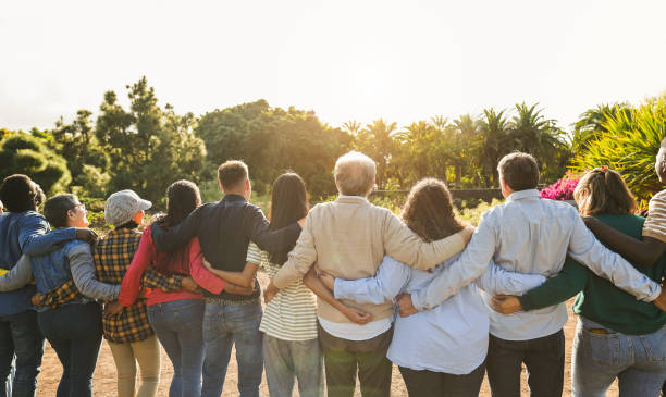 istock Group of multigenerational people hugging each others - Support, multiracial and diversity concept - Main focus on senior man with white hairs 2135179406