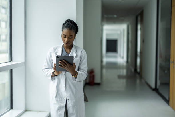 istock Female doctor using digital tablet in clinic hallway 2135180436