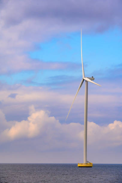 Wind turbines producing sustainable renewable energy in a wind park in Flevoland, The Netherlands, during a stormy springtime day.