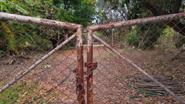 Rusty Metal Gates Securing Garden Entrance