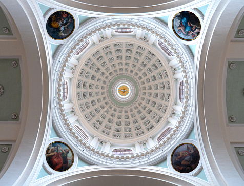 The inside of a dome of a church from below in Urbino, Italy