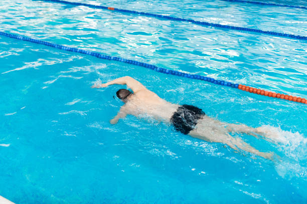 Swimming competition in the swimming pool, close up of water splashes
