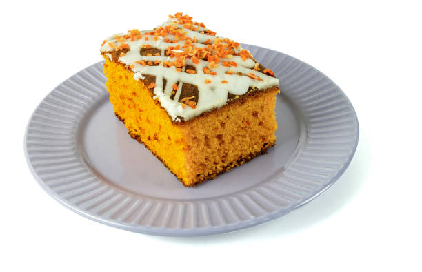 Slice of Thanksgiving holiday pumpkin pie with whipped topping served on a plate