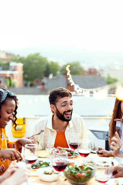 istock Group of young people having fun toasting red wine at bbq rooftop party 2135240877