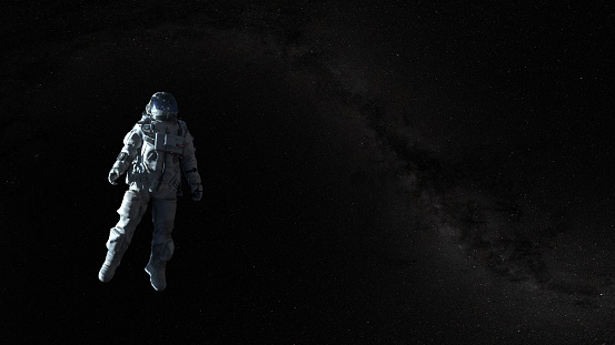 Spaceman on a black background hovering in an outer space. Astronaut in a space