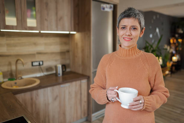 istock Mature woman in the kitchen drinking her morning coffee 2135288194