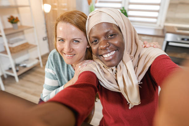 istock Two multiracial female friends at home 2135289908