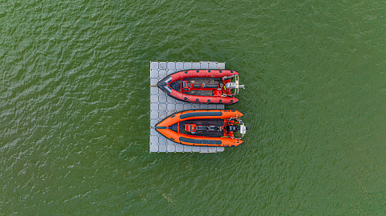 Aerial photo from a drone of a couple of rib boats stored on a floating mooring jetty/dock/platform.