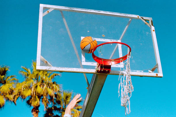 istock hand throwing ball to hoop 2135295887