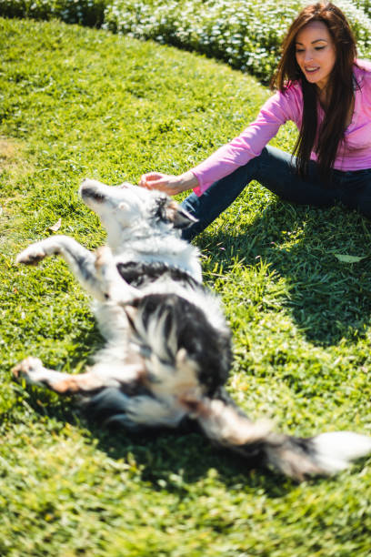 istock woman playing with the dog 2135296412