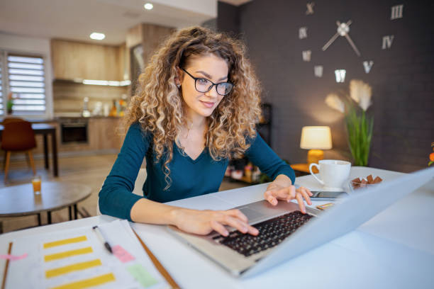 istock Young woman working on laptop at home 2135301696