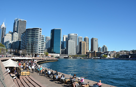 Sydney, Australia - July 27, 2014: A view of people relaxing at outdoor tables on Bennelong Point in Sydney, Australia.