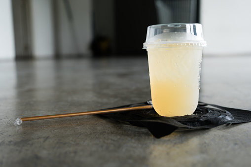 A glass of cold lemon juice mixed with honey. A cool drink is used to quench your thirst during exhausting times.