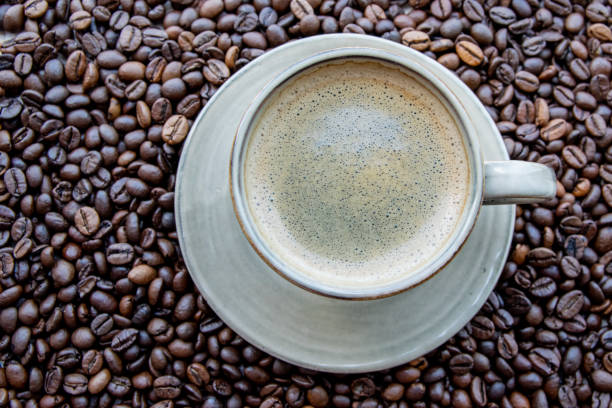 istock Cup with coffe on the roasted coffe beans. 2135323413