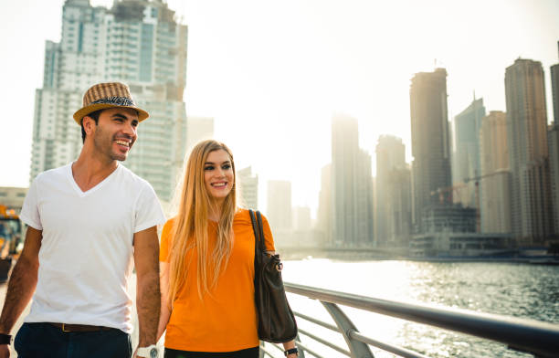 istock Couple in Dubai Marina walking togethers 2135366349