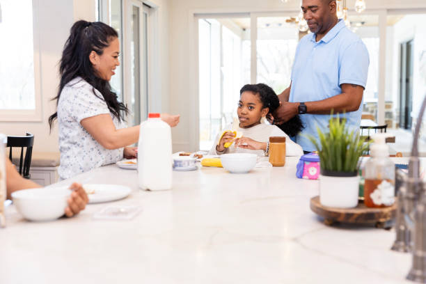 istock Low angle view family eating and talking in kitchen 2135380530