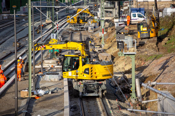 Frankfurt, Germany - February 05, 2024: Railroad construction site in Frankfurt-Eschersheim - track workers laying rail tracks and building a railroad station platform