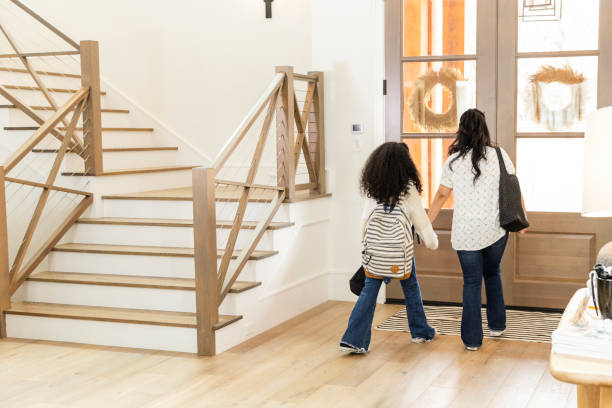 istock Rear view mom and daughter heading out hand-in-hand 2135381081