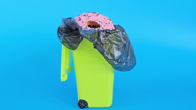 Donut is thrown into the trash bin. Refusal of high calorie foods