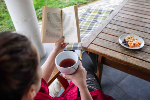 istock Woman in Spa Robe Reading a Book 2135389507