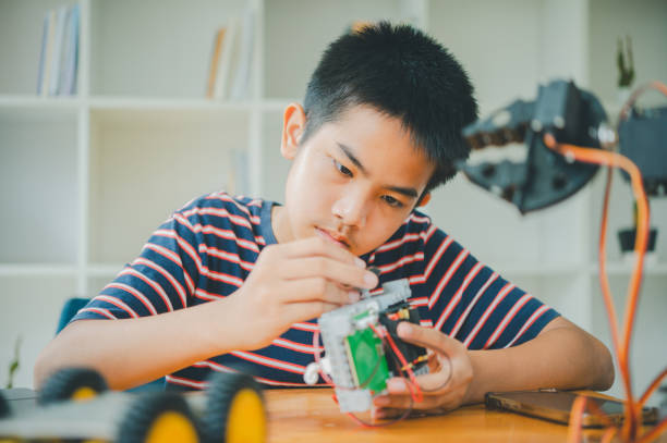 istock Asian boy learning and studying the work of technology robots.homeschool and science for tech project. playing childhood kids hobby leisure lifestyle people toys robotics technology. 2135406102