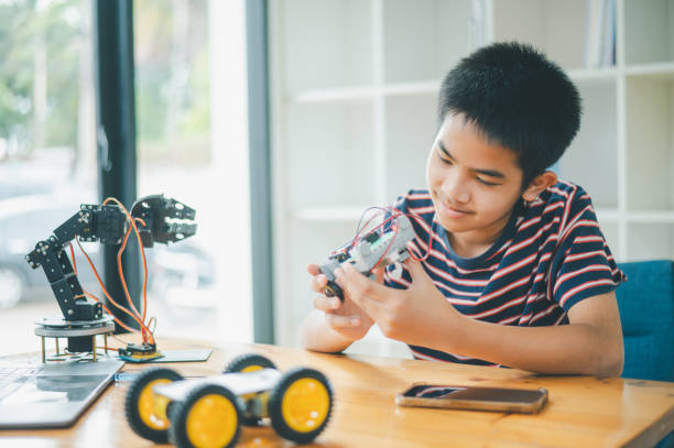 istock Asian boy learning and studying the work of technology robots.homeschool and science for tech project. playing childhood kids hobby leisure lifestyle people toys robotics technology. 2135407419
