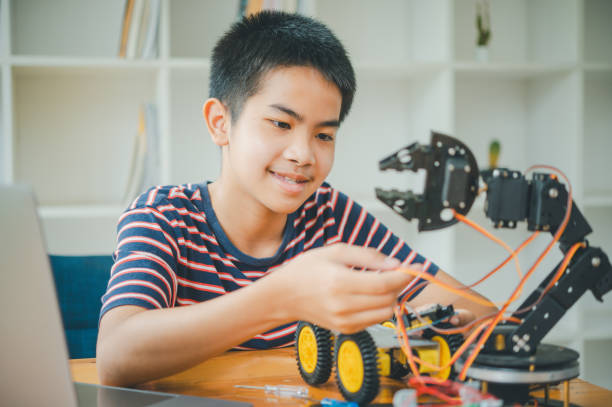 istock Asian boy learning and studying the work of technology robots.homeschool and science for tech project. playing childhood kids hobby leisure lifestyle people toys robotics technology. 2135410140