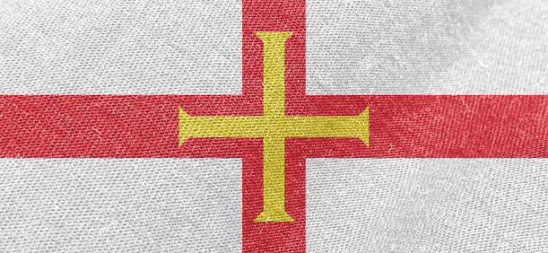 Guernsey flag fabric cotton material wide flag wallpaper, Textured national flag of Guernsey for graphic and web design purposes.