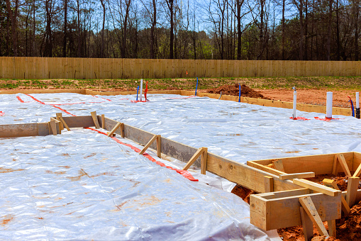 Immediately prior to pouring of foundation, ground is covered with first layer insulation waterproofing membrane