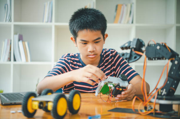 istock Asian boy learning and studying the work of technology robots.homeschool and science for tech project. playing childhood kids hobby leisure lifestyle people toys robotics technology. 2135451467