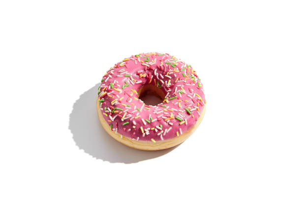 istock Pink glazed donut with colorful sprinkles isolated on a white background 2135456385