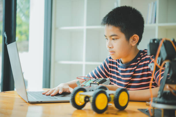 istock Asian boy learning and studying the work of technology robots.homeschool and science for tech project. playing childhood kids hobby leisure lifestyle people toys robotics technology. 2135457438