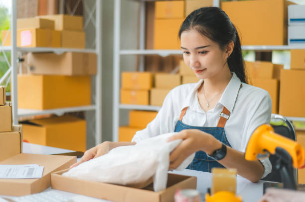 istock Online small business owners are packing their ordered products that customers order online into a box .concept of online shopping 2135459543