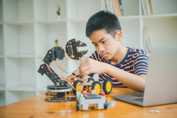 istock Asian boy learning and studying the work of technology robots.homeschool and science for tech project. playing childhood kids hobby leisure lifestyle people toys robotics technology. 2135468764