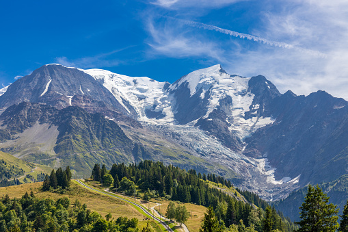 Tour du Montblanc beautiful mountain peaks and green valley. TMB trekking route scenic landscape in italian, swiss and french Alps in Chamonix valley alpine scene