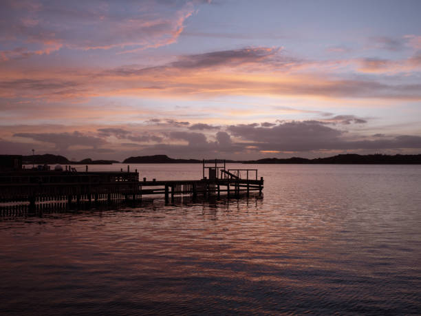 istock Tranquil sunset reflects on the calm water and dock 2135507136