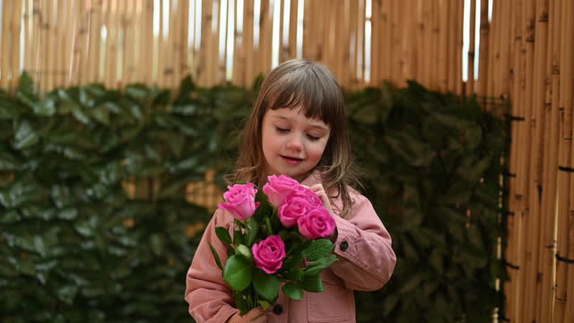 little girl with pink roses.