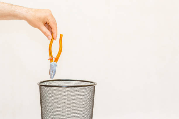 istock The construction pliers is thrown into the trash basket.White,gray background,selective focus,copy space. 2135522441