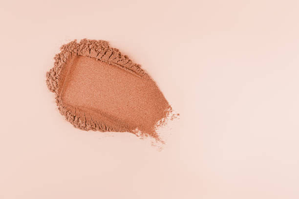 istock Loose powder swatch for face makeup. bronzer tone. Light and delicate powder structure. Pastel background. A copy space. layout. mockup 2135530641