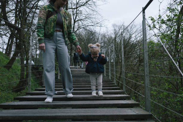 Mother and toddler walk down steps outdoors