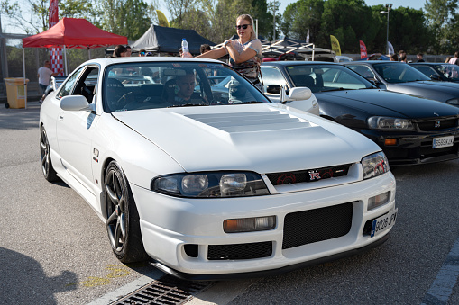 Montmelo, Spain – October 20, 2023: Front view of a white ninth-generation Nissan Skyline GT R33 at a Japanese sports car meet.
