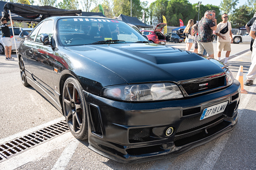 Montmelo, Spain – October 20, 2023: Front view of a black ninth-generation Nissan Skyline GT R33 GTS25t at a Japanese sports car meet.
