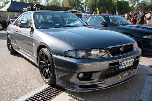 Montmelo, Spain – October 20, 2023: Front view of a gray ninth-generation Nissan Skyline GT R33 at a Japanese sports car meet.