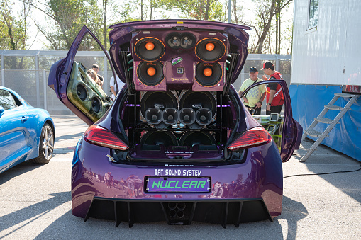 Montmelo, Spain – October 20, 2023: An unrecognizable Peugeot 206 GTI fully tuned with scissor doors. It is full of speakers with sound power, parking music